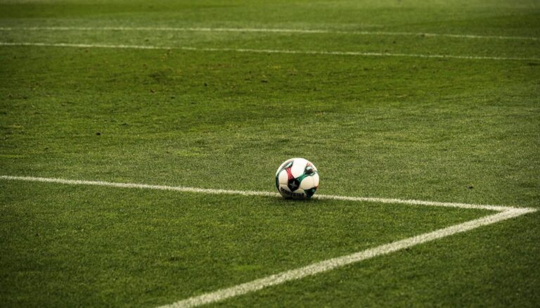 Soccer ball on an empty green football field